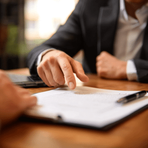 Dallas car accident lawyer lawyer negotiating with the insurance company, pointing at the contract